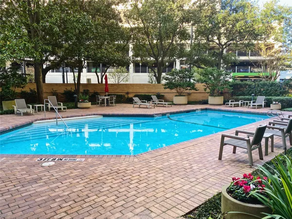 a swimming pool with outdoor seating and yard