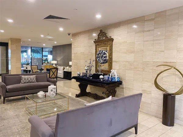 a living room with furniture and a mirror