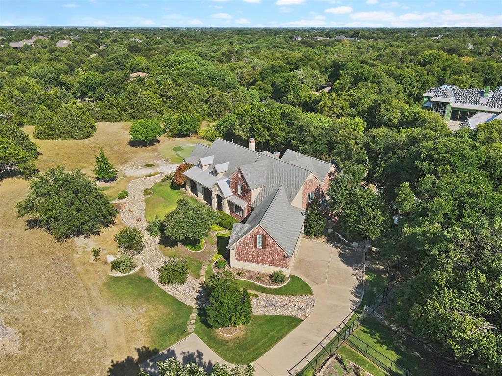 1815 West Forest Grove Road Lucas, TX 75002 - Photo 3 of 39 an aerial view of a house with a garden and lake view