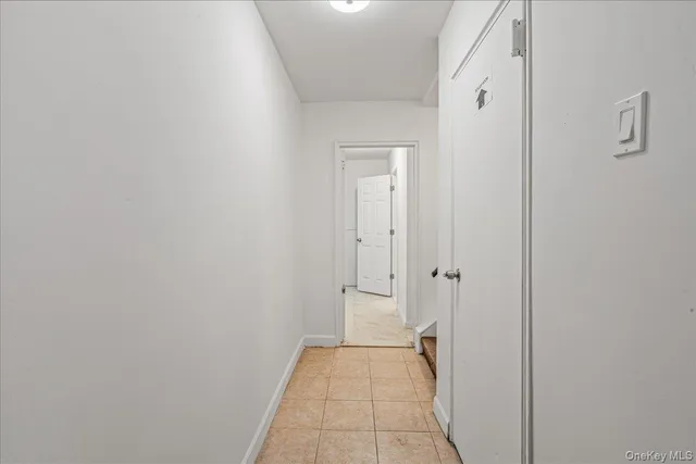 a view of a hallway with wooden floor and closet