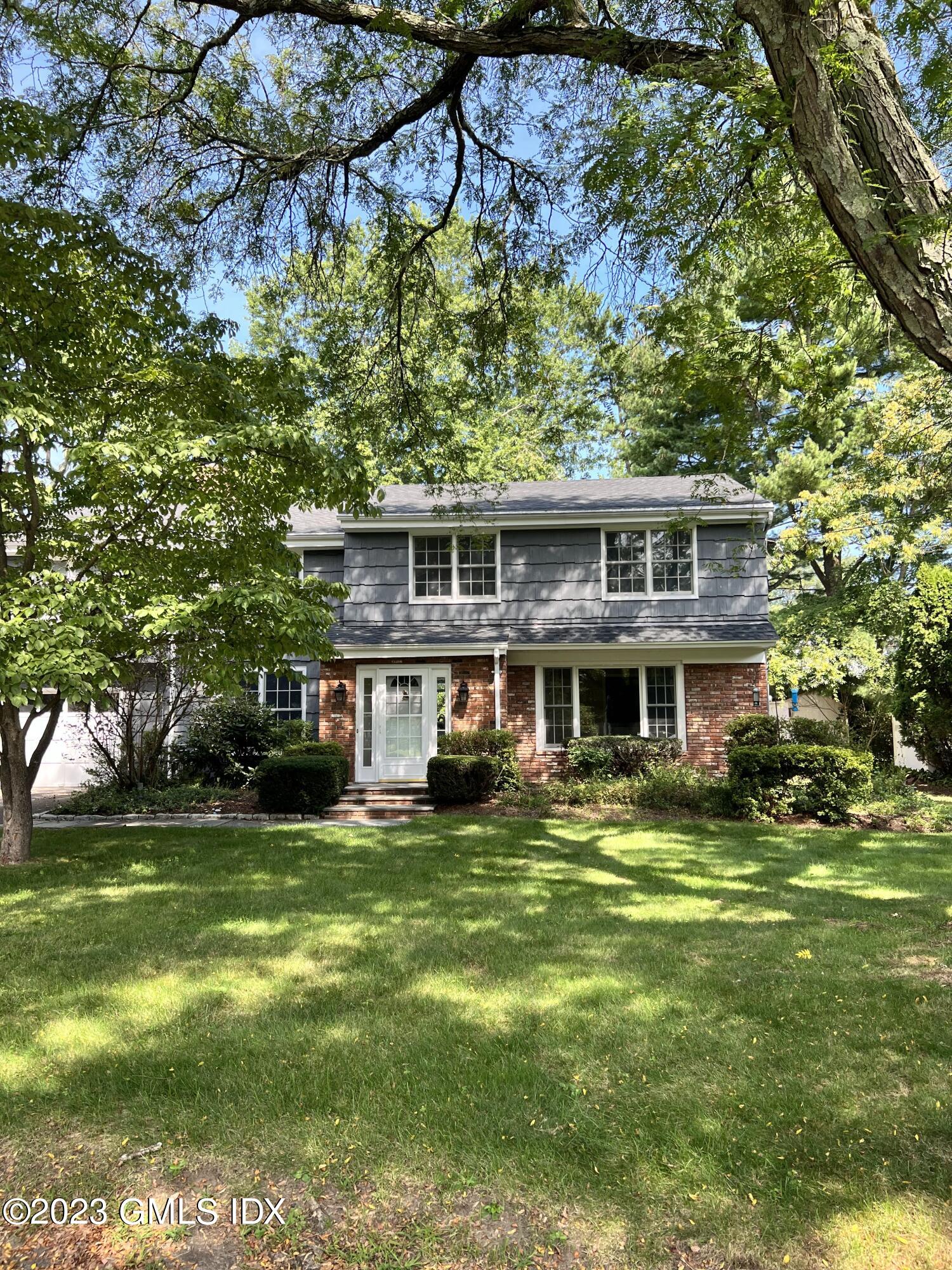 5 Tory Road Riverside, CT 06878 - Photo 25 of 26 a view of a house with a big yard and potted plants and large trees