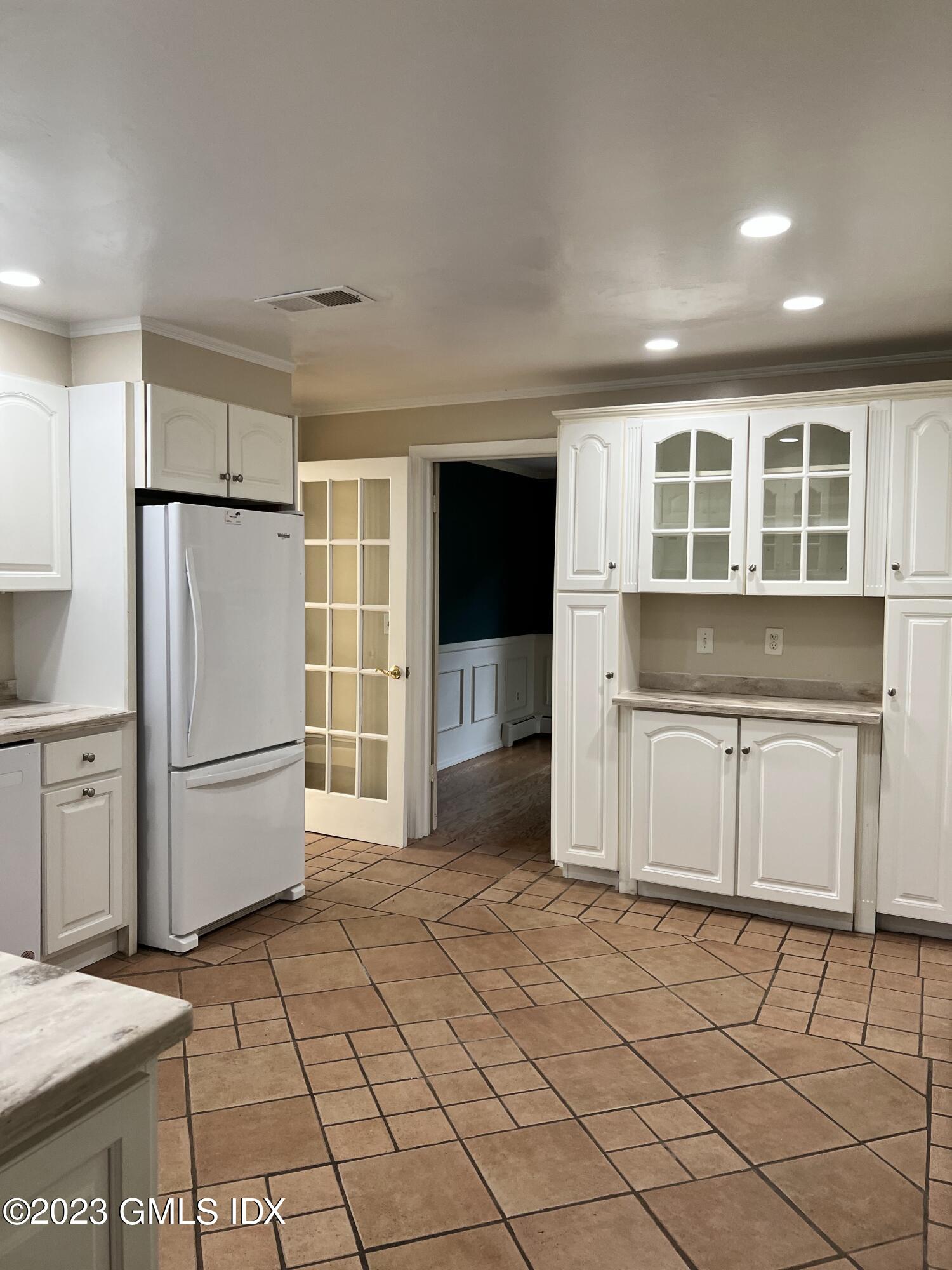 5 Tory Road Riverside, CT 06878 - Photo 7 of 26 a kitchen with a refrigerator and a stove top oven