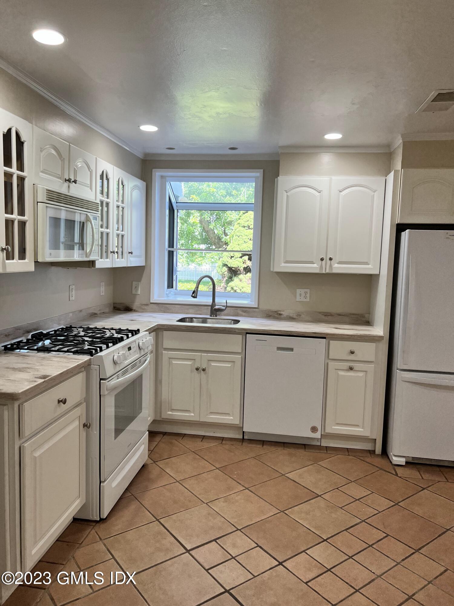 5 Tory Road Riverside, CT 06878 - Photo 8 of 26 a kitchen with a stove a sink and a refrigerator