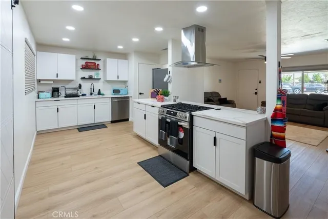 a kitchen that has a sink and a stove in it