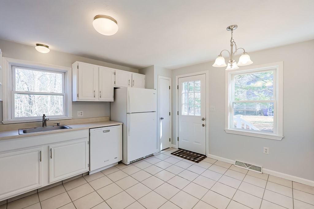 131 Harkness Road, Unit B Millville, MA 01529 - Photo 16 of 41 a kitchen that has a lot of cabinets in it and a window