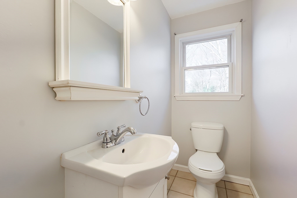 131 Harkness Road, Unit B Millville, MA 01529 - Photo 23 of 41 a bathroom with a toilet sink and mirror