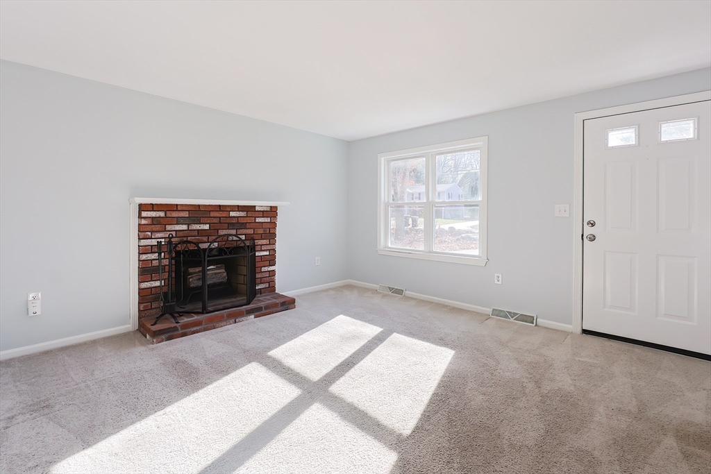 131 Harkness Road, Unit B Millville, MA 01529 - Photo 26 of 41 a view of an empty room with a fireplace and a window