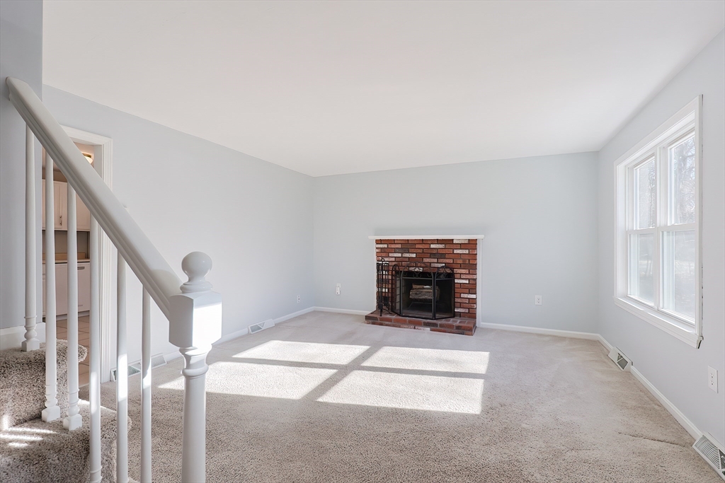 131 Harkness Road, Unit B Millville, MA 01529 - Photo 29 of 41 a view of an empty room with fireplace and a window