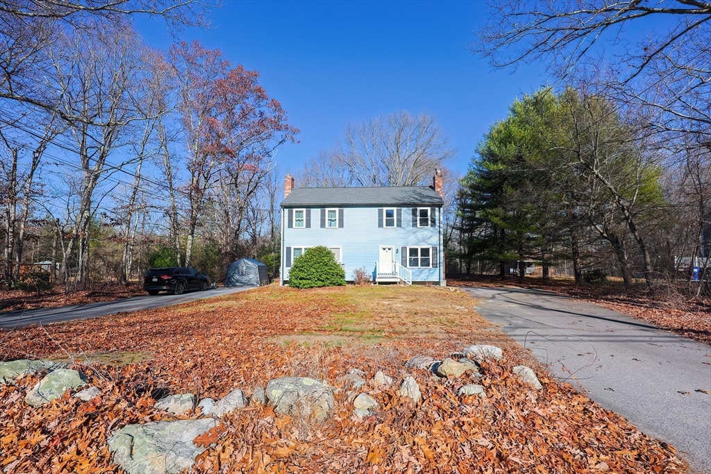 131 Harkness Road, Unit B Millville, MA 01529 - Photo 3 of 41 a front view of a house with a yard and a garage