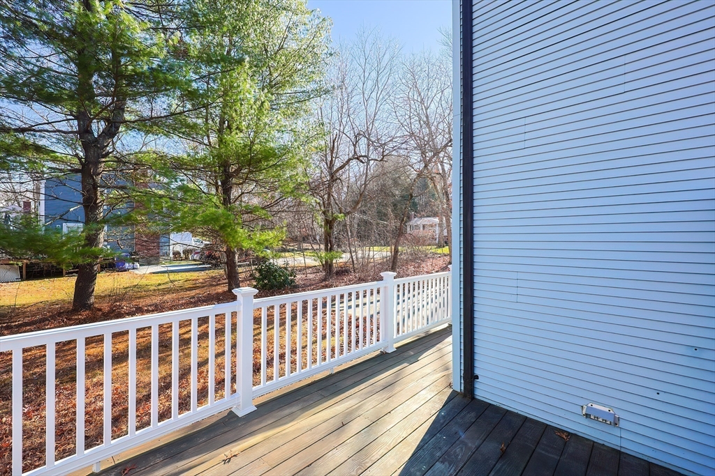 131 Harkness Road, Unit B Millville, MA 01529 - Photo 10 of 41 a view of a wooden balcony with trees