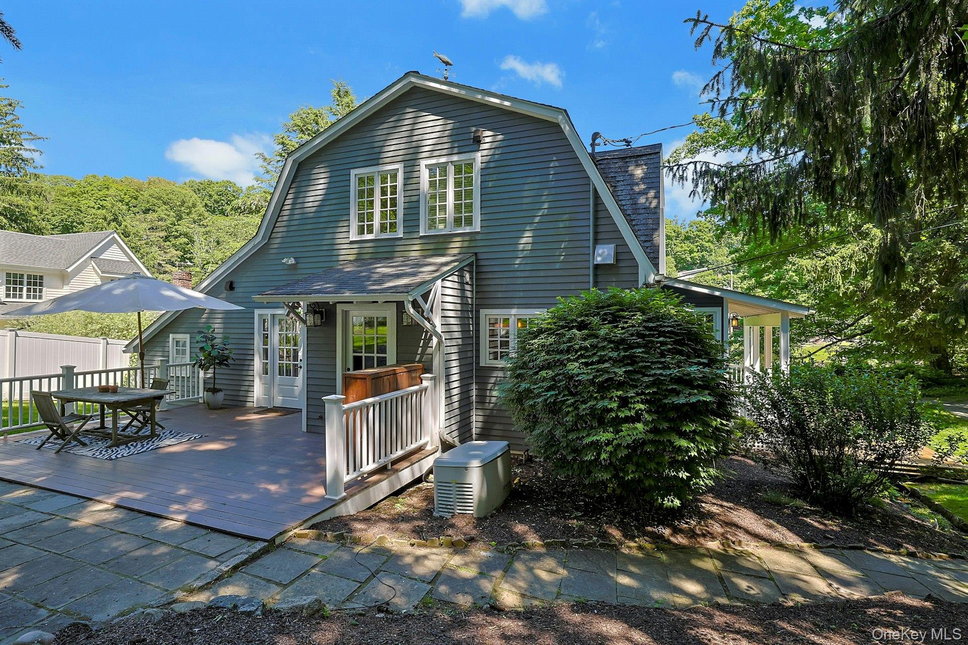 65 Douglas Road Chappaqua, NY 10514 - Photo 33 of 41 A charming side view of the home highlights a lovely walkway to the front of the house