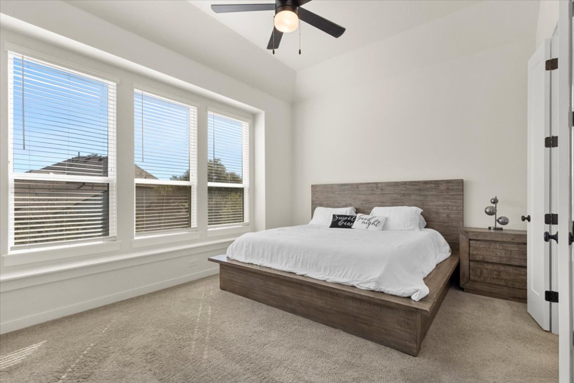 1020 Highcrest Georgetown, TX 78628 - Photo 14 of 39 a large bed sitting in a bedroom next to a window
