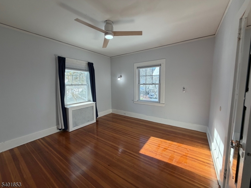 63 Watchung Avenue, Unit 2 Montclair, NJ 07043 - Photo 12 of 21 an empty room with wooden floor and windows