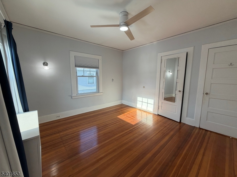 63 Watchung Avenue, Unit 2 Montclair, NJ 07043 - Photo 13 of 21 an empty room with wooden floor and windows