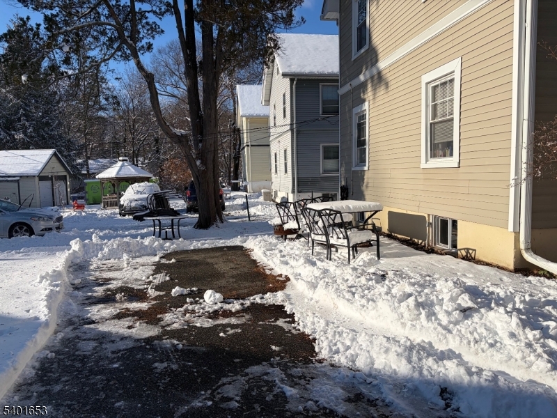 63 Watchung Avenue, Unit 2 Montclair, NJ 07043 - Photo 20 of 21 a view of a patio with a table and chairs under an umbrella