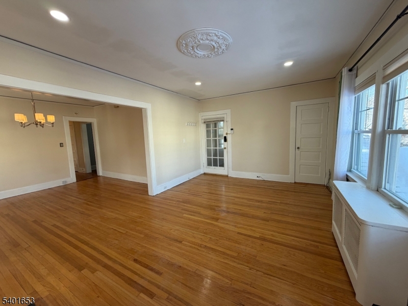63 Watchung Avenue, Unit 2 Montclair, NJ 07043 - Photo 2 of 21 a view of an empty room with wooden floor and a window