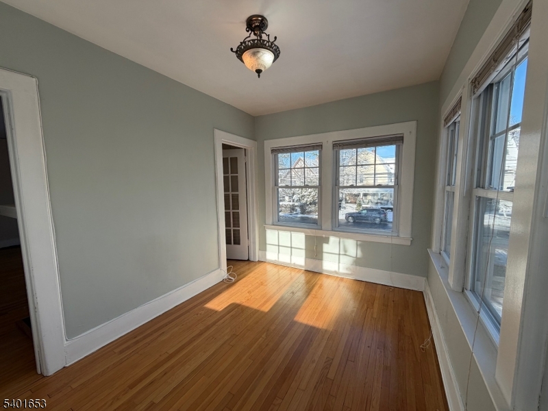63 Watchung Avenue, Unit 2 Montclair, NJ 07043 - Photo 4 of 21 a view of an empty room with wooden floor and a window