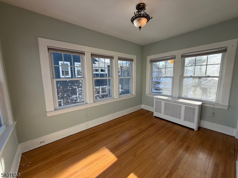 63 Watchung Avenue, Unit 2 Montclair, NJ 07043 - Photo 5 of 21 a view of an empty room with a window and wooden floor