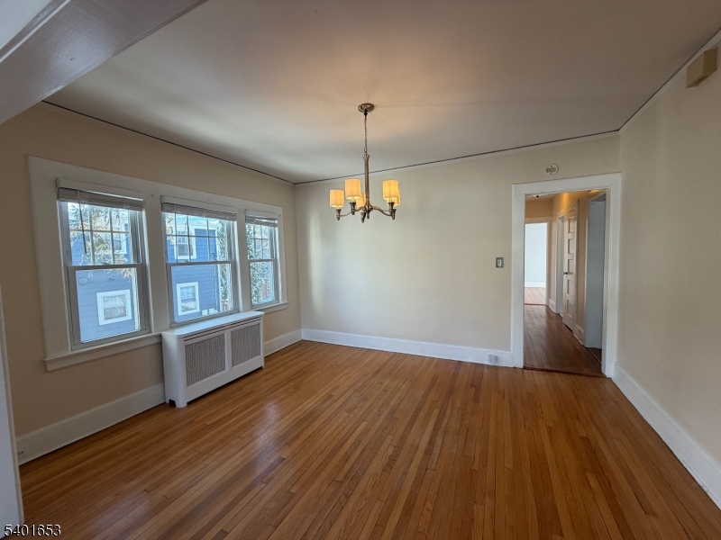 63 Watchung Avenue, Unit 2 Montclair, NJ 07043 - Photo 7 of 21 an empty room with wooden floor cabinet and windows