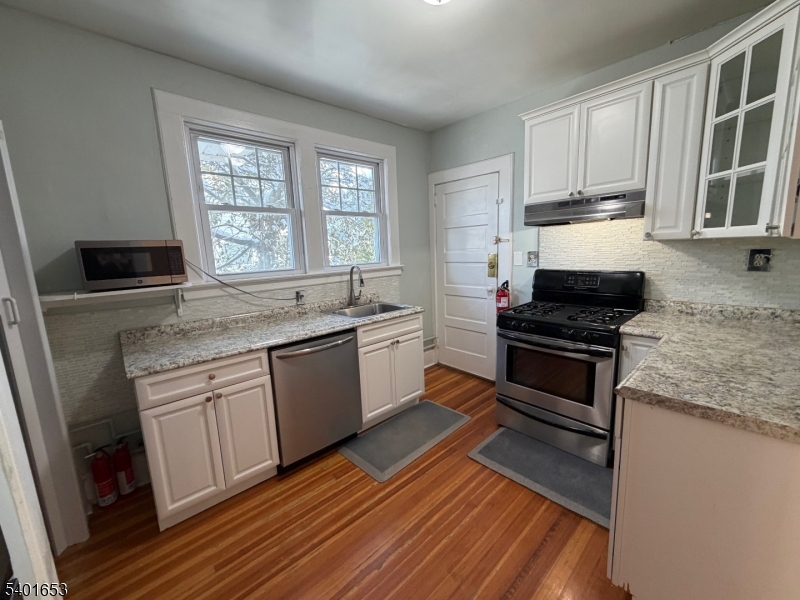63 Watchung Avenue, Unit 2 Montclair, NJ 07043 - Photo 8 of 21 a kitchen with a sink stove top oven and cabinets