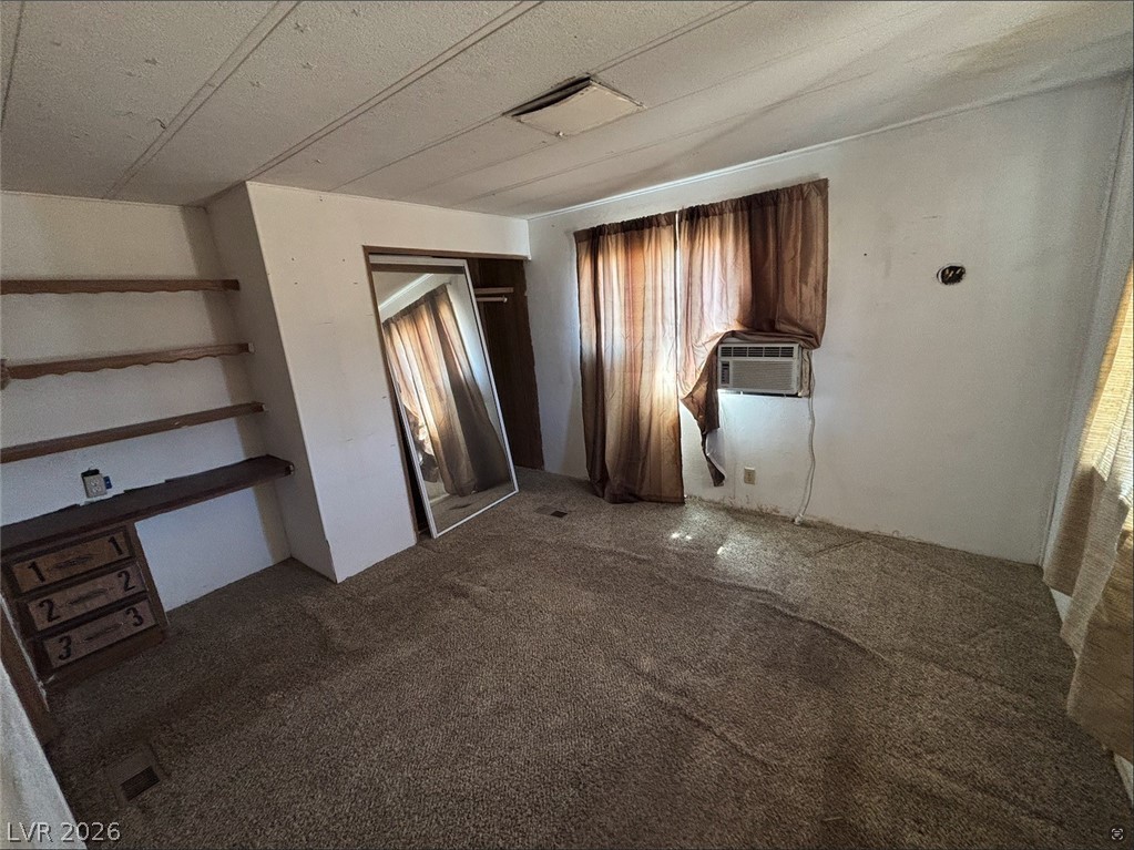 1301 East Manse Road Pahrump, NV 89048 - Photo 13 of 14 An accommodating bedroom with built-in shelving offers ample storage and space for personalization.