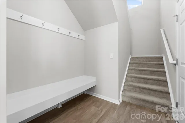 a view of entryway with stairs and wooden floor