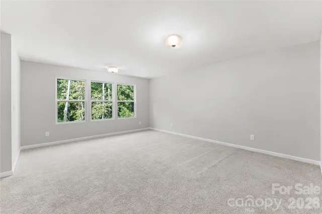 an empty room with windows and yard