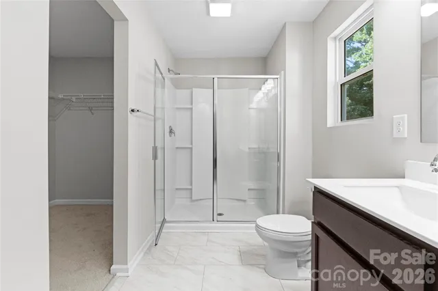 a bathroom with a toilet a sink and shower
