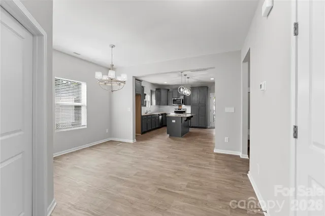 a view of a living room and kitchen with a large window