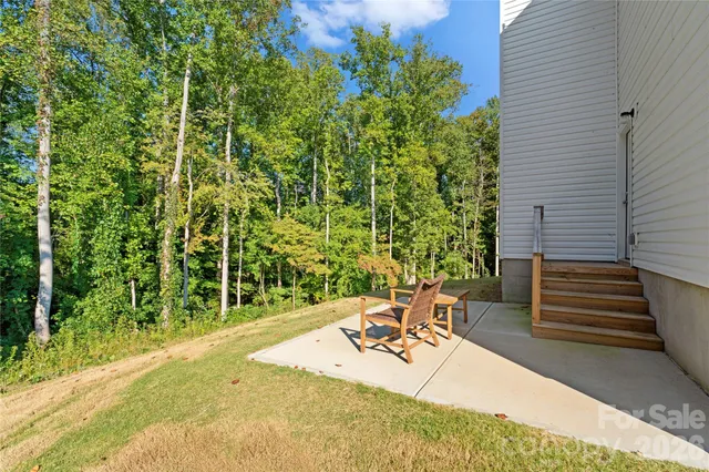 a view of a backyard with plants and a patio
