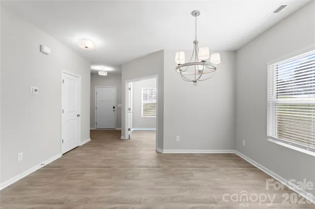a view of a room with window wooden floor