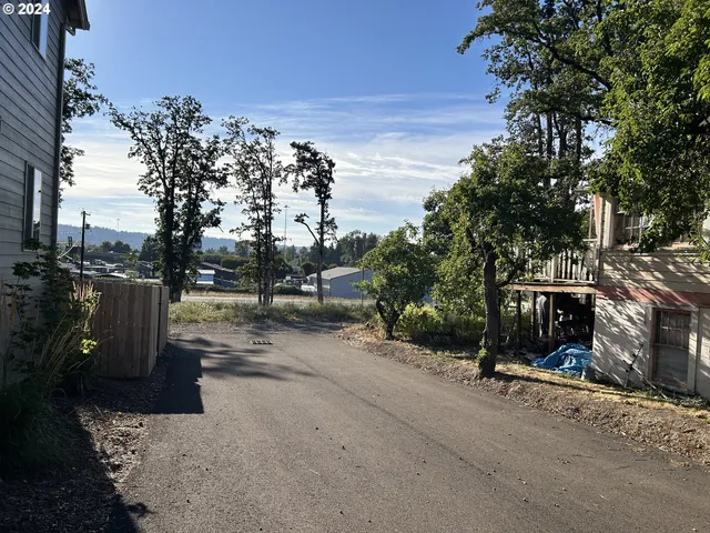 a view of a street with a bench in the patio