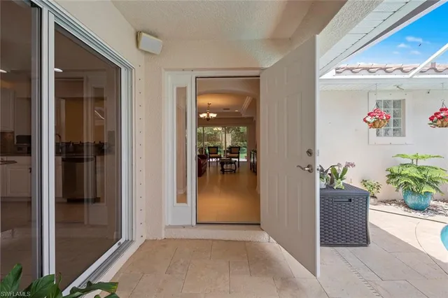a dining room with furniture and chandelier
