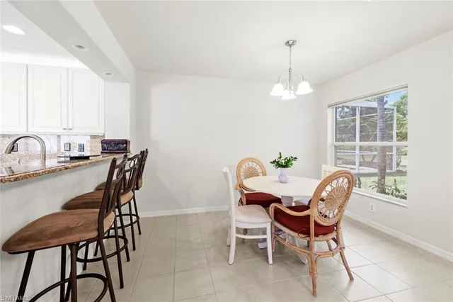 a bedroom with a bed chandelier and window
