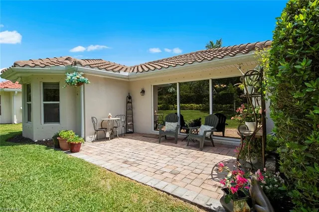 a swimming pool with outdoor seating and yard