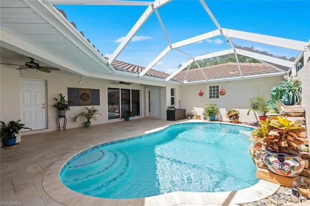 a view of a hallway to a livingroom with furniture