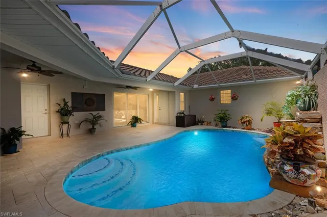 a view of a hallway with kitchen space and a window
