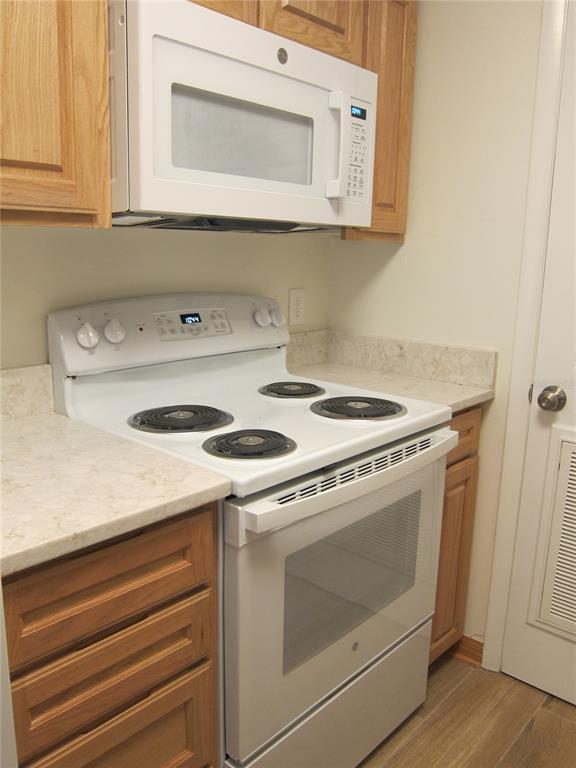 7023 Southwest 21st Lane Gainesville, FL 32607 - Photo 11 of 27 a kitchen with a stove and white cabinets