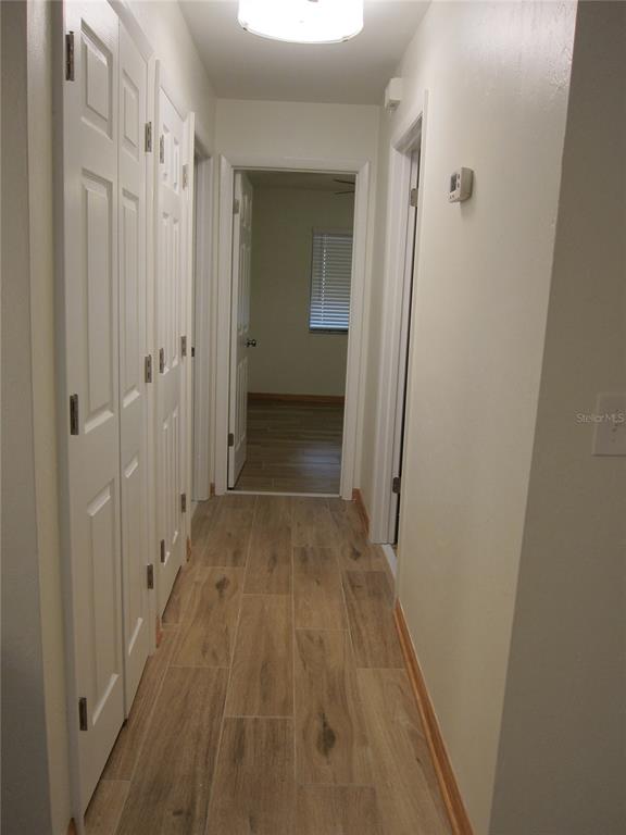 7023 Southwest 21st Lane Gainesville, FL 32607 - Photo 12 of 27 a view of a hallway with wooden floor
