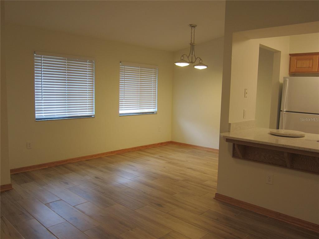 7023 Southwest 21st Lane Gainesville, FL 32607 - Photo 14 of 27 a view of an empty room with wooden floor and a window