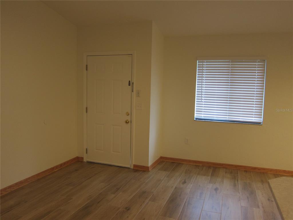 7023 Southwest 21st Lane Gainesville, FL 32607 - Photo 15 of 27 a view of an empty room with wooden floor and a window