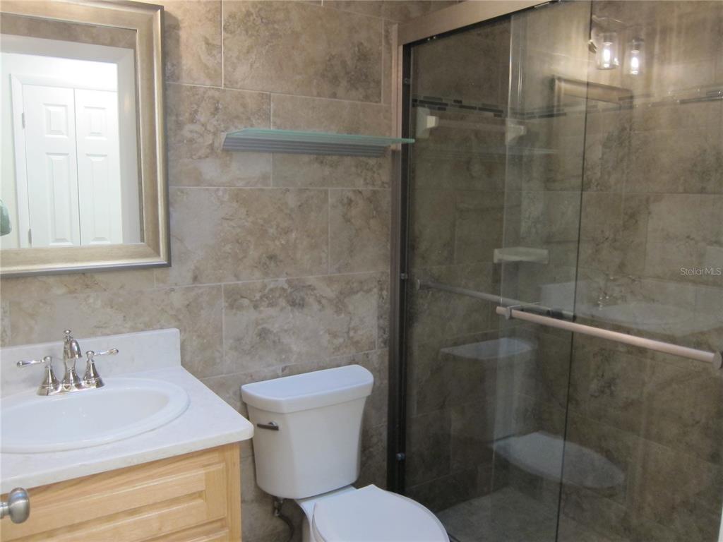7023 Southwest 21st Lane Gainesville, FL 32607 - Photo 16 of 27 a bathroom with a sink toilet and shower