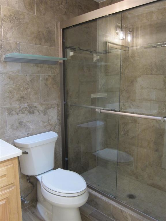7023 Southwest 21st Lane Gainesville, FL 32607 - Photo 17 of 27 a white toilet next to a bathroom shower