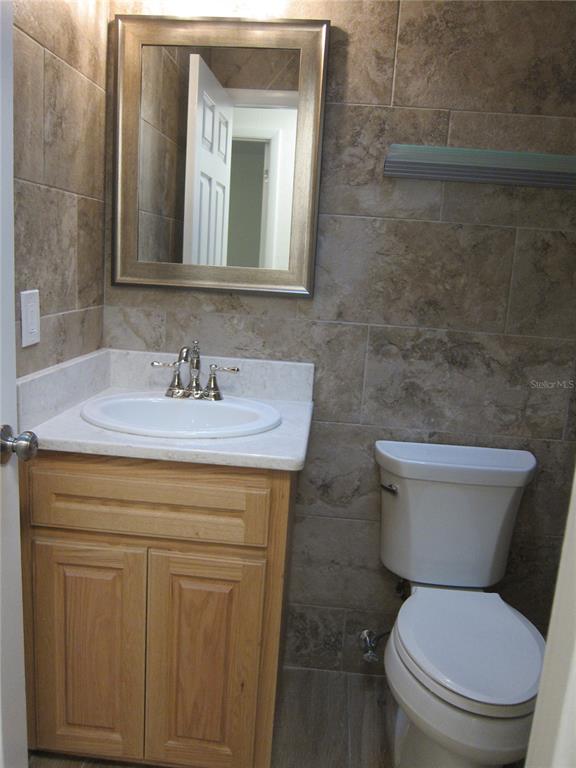7023 Southwest 21st Lane Gainesville, FL 32607 - Photo 19 of 27 a bathroom with a toilet sink and mirror