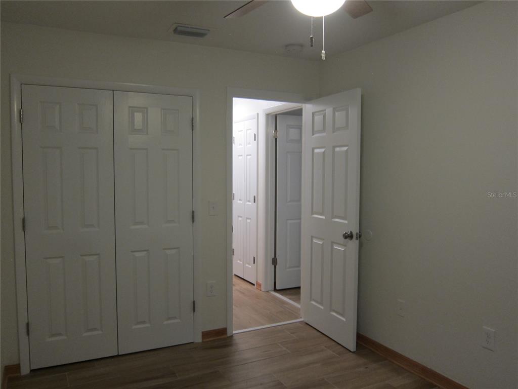 7023 Southwest 21st Lane Gainesville, FL 32607 - Photo 22 of 27 a view of a hallway with wooden floor