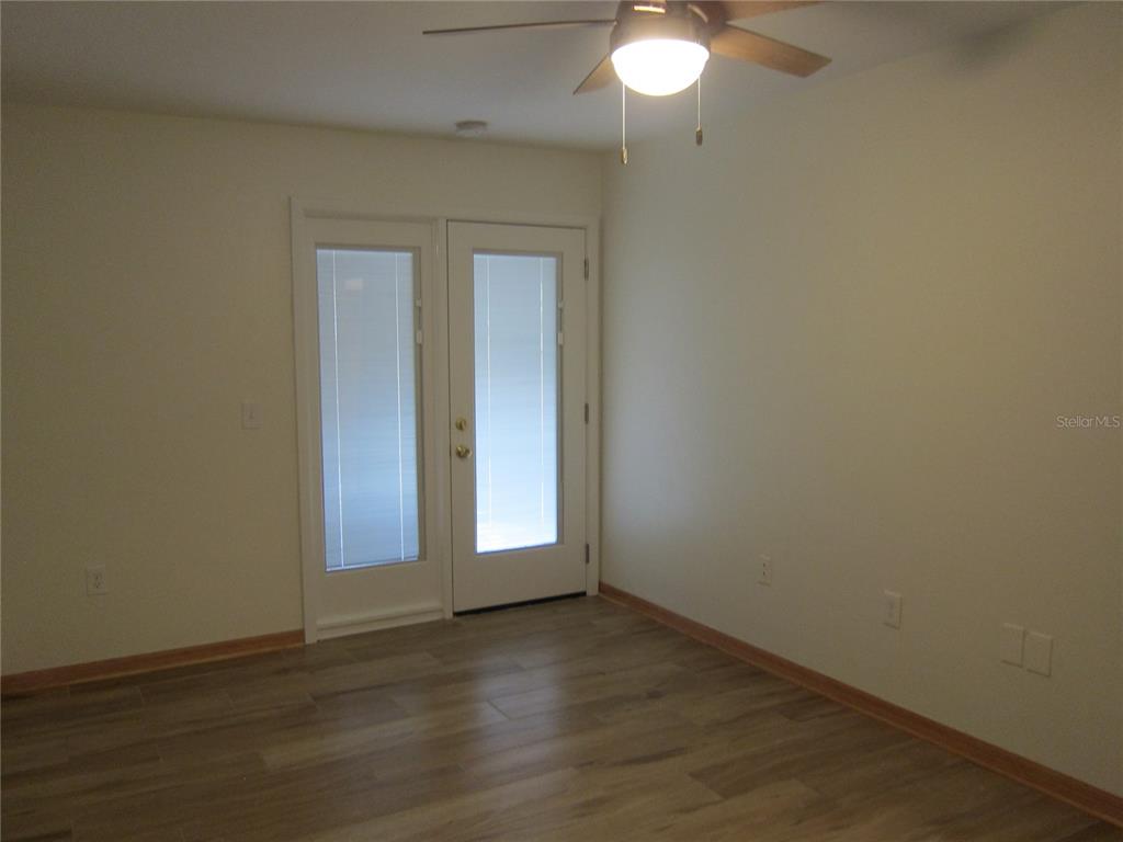 7023 Southwest 21st Lane Gainesville, FL 32607 - Photo 24 of 27 an empty room with wooden floor and windows