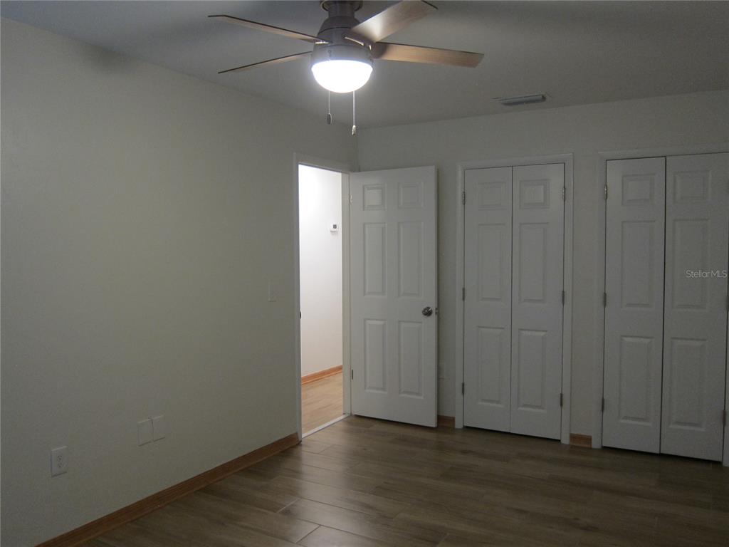 7023 Southwest 21st Lane Gainesville, FL 32607 - Photo 25 of 27 a view of an empty room with wooden floor