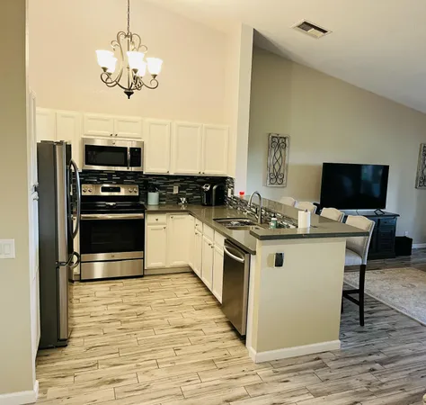 a kitchen with stainless steel appliances granite countertop a stove and a microwave