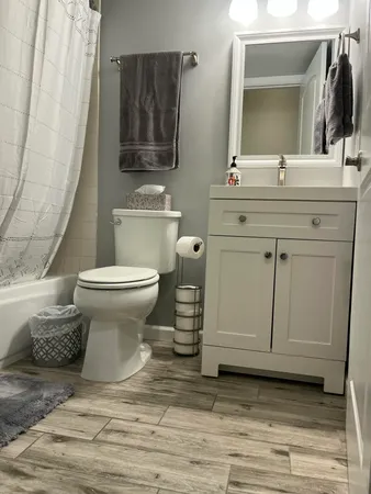 a bathroom with a sink toilet and mirror