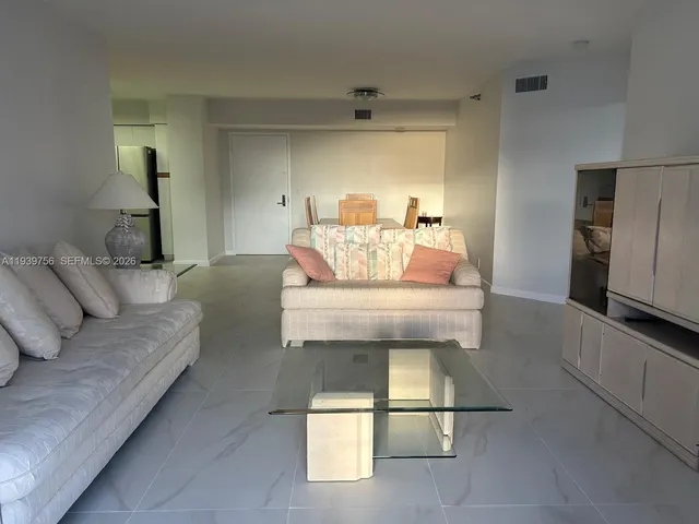 a living room with furniture and a walk in closet